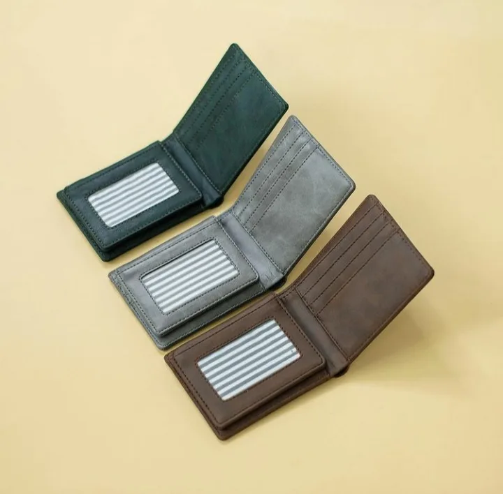 Tiga dompet bifold terbuka warna hijau tua, abu-abu, dan cokelat tua dengan jendela kartu identitas, disusun bertumpuk di atas latar krem kekuningan